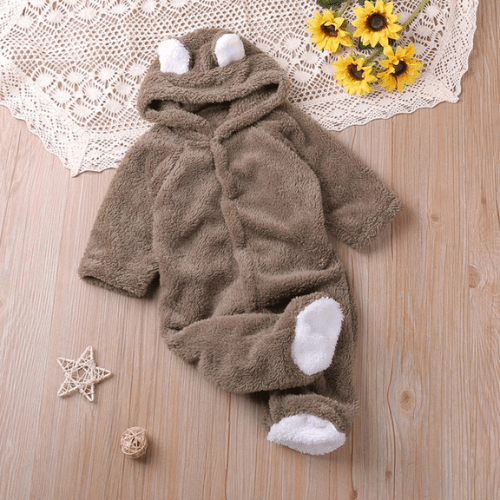 Combinaison pilote bébé en polaire brune avec capuche à oreilles d'ours, tenue chaude et douce pour nouveau-nés et tout-petits.