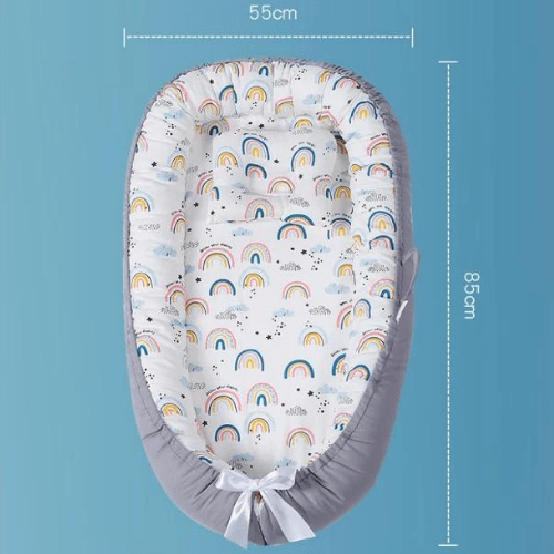 Réducteur de lit bébé arc-en-ciel, cocon doux et sécurisé en tissu coton respirant, dimensions 55x85 cm, confortable et portable pour nouveau-nés.