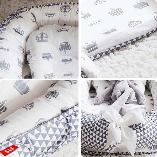 Réducteur de lit bébé blanc avec motifs de couronnes grises, coussin assorti, tissu 100% coton, design ajustable et sécurisant pour nouveau-né.