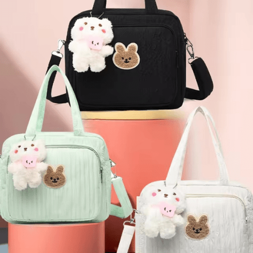 Sac à langer dessin animé pour parents modernes avec motifs adorables, multiple poches, design léger et fonctionnel en noir, vert et blanc.